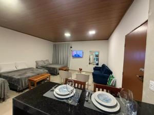 a living room with a bed and a dining table at Condomínio Feitosa Barros II in Maceió