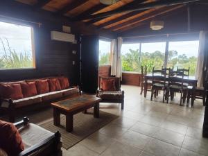 a living room with a couch and a table and chairs at Las palmas in Costa Azul +22 photos