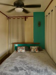 a bedroom with a bed with a ceiling fan at Chill Studio Near Beach Tamarindo in Tamarindo