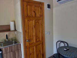 a kitchen with a wooden door next to a sink at Chill Studio Near Beach Tamarindo in Tamarindo