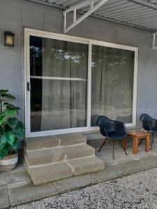a porch with two chairs and a window at Chill Studio Near Beach Tamarindo in Tamarindo