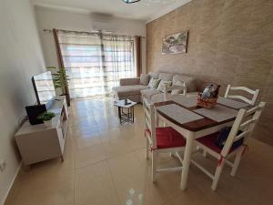 a living room with a table and a couch at Os Robalos in Moura