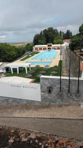 a swimming pool with a sign in front of it at Os Robalos in Moura