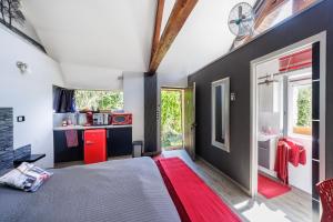a bedroom with a large bed and a bathroom at chambre mil roses in Andé