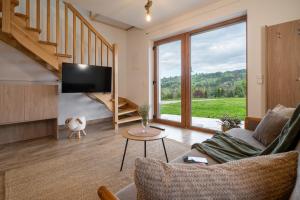 a living room with a couch and a tv at Biała Owca in Biały Dunajec