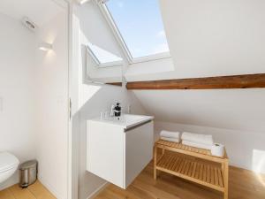 a bathroom with a sink and a skylight at De Loft in Veurne +57 photos
