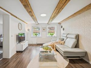 a living room with a couch and a table at Modern apartments harz I in Elbingerode