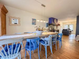 a kitchen with a large table with blue chairs at Zum Anker in Bernkastel-Kues