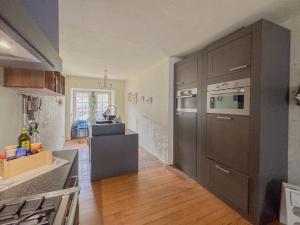 a kitchen with stainless steel appliances and wooden floors at Zum Anker in Bernkastel-Kues +35 photos