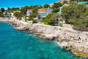 an aerial view of a river with rocks and houses at Apartments by the sea Bilo, Primosten - 4806 in Podgreben