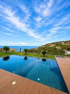 a swimming pool with a view of the ocean at Villa Livramento in Ponta do Sol