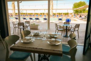 a table and chairs with a view of a pool at Imperial Hotel in Tale