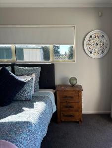 a bedroom with a bed and a nightstand and a window at Studio Haven on Fort in Cambridge +2 photos