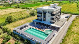 an aerial view of a building with a swimming pool at Imperial Hotel in Tale