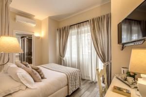 Postel nebo postele na pokoji v ubytování Casa Mia Vaticano Guest House