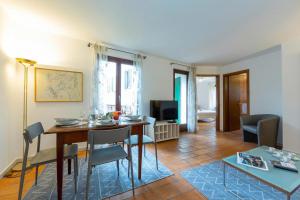 a living room with a table and a dining room at Casa Chiara Muralto with Balcony & Wi‑Fi - Happy Rentals in Locarno