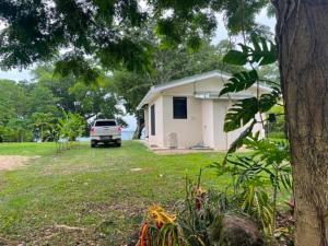 a white truck parked in front of a house at Helt Vanua Lodge in Saraotou