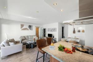 a kitchen and living room with a table with vegetables on it at Art Apartment Locarno - Balcony and Parking - Happy Rentals in Locarno
