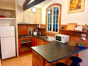 a kitchen with a white refrigerator and a counter top at 2 bedroom Guesthouse in the Centre of Noojee in Noojee