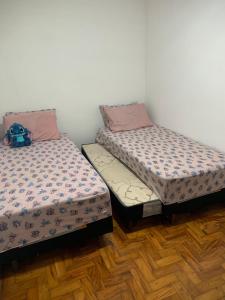 two beds sitting next to each other in a room at Casa com 1 quarto e 6 camas in Campinas