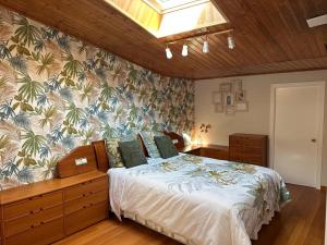 a bedroom with a bed in a room with a wall at Rincón Atlántico ático deluxe in Moaña
