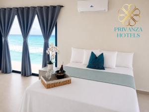 a bedroom with a bed with a view of the ocean at Privanza Hotels in Santa Cruz de Barahona