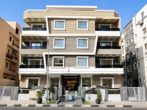 a person standing in front of a building at Stay Inn 51 Hotel Zayed in Sheikh Zayed
