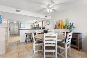 a kitchen and dining room with a table and chairs at Edgewater Condo Unit #304 in South Padre Island