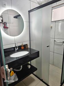 a bathroom with a sink and a mirror and a shower at Apart ZSS in Penha +39 photos
