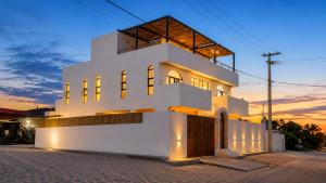 a white house with a sunset in the background at Villa Atlantica - Preá in Prea