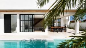 an external view of a house with a swimming pool at Villa Atlantica - Preá in Prea