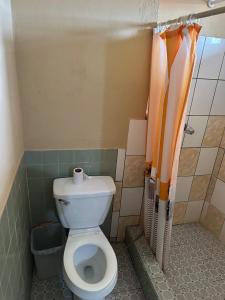 a bathroom with a toilet in a small room at Cabinas Hilda in Canoas