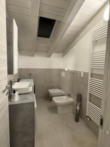 a bathroom with a sink and a toilet and a sink at Felicita Cascata Terrace with Lake View in Lecco +47 photos