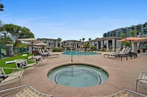 a patio with a pool with chairs and a table at Remodeled King Bed Suite Sonoran Sunset Lounge in Scottsdale