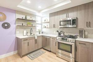 a kitchen with a stove and a microwave at Remodeled King Bed Suite Sonoran Sunset Lounge in Scottsdale