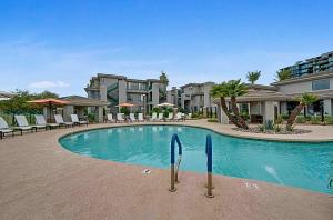 a swimming pool at a resort with tables and chairs at Remodeled King Bed Suite Sonoran Sunset Lounge in Scottsdale +27 photos
