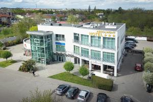 an aerial view of a hotel with cars parked in a parking lot at Hotel Absolwent in Gostyń