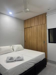 a bedroom with a bed with two towels on it at Student Site - Coliving Hotel in Montería