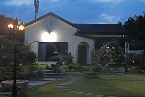 a house with a light on the front of it at Sarah's Small Garden in Cheonan