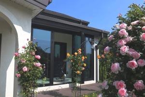 a house with flowers in front of a window at Sarah's Small Garden in Cheonan