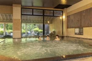 a group of people in a swimming pool at Ooedo Onsen Monogatari Premium Saiki Bekkan in Misasa +49 photos