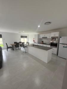 a kitchen and dining room with a table and chairs at The Holiday Home Griffith in Griffith