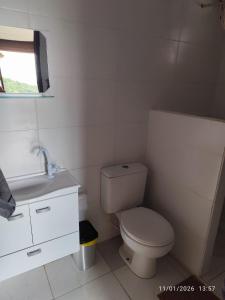 a small bathroom with a toilet and a sink at Chacara Pôr do Sol Capivari in Campina Grande do Sul +48 photos
