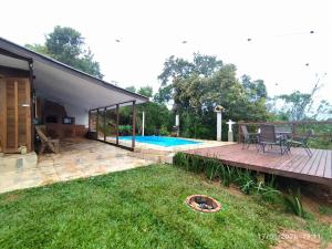 a backyard with a deck and a swimming pool at Chacara Pôr do Sol Capivari in Campina Grande do Sul
