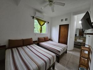 a bedroom with two beds and a window at Alojamiento La Vista in Barrio Nuevo +16 photos