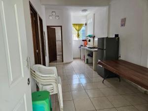 a kitchen with a table and chairs and a refrigerator at Alojamiento La Vista in Barrio Nuevo