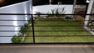 a view through a window of a yard at Complejo Terranova in Aimogasta