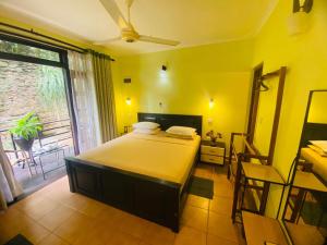 a bedroom with a bed and a large window at Nature Walk Resort in Kandy +96 photos