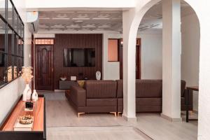 a living room with a couch and a tv at Kumbaya Apartments in Achimota