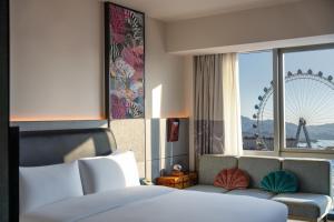a hotel room with a bed and a large window at SSAW Yintai Boutique Hotel Qiandao Lake in Chun'an +34 photos